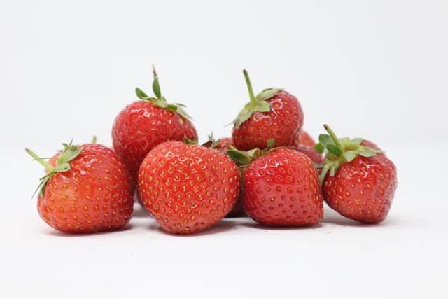 A bunch of strawberries. What are the benefits of feeding strawberries to rabbits?
