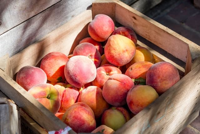 Red peaches in a crate