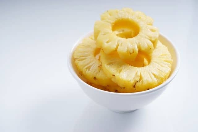 A pealed pineapple in a bowl