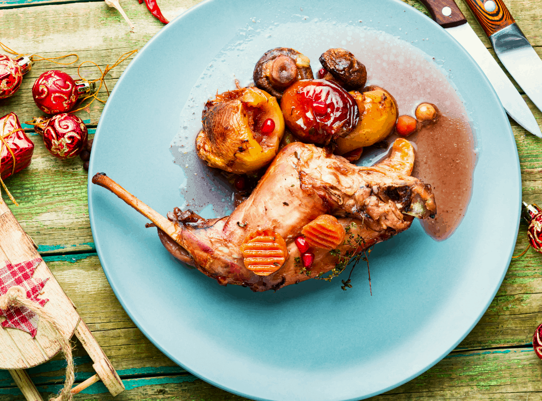 Cooked rabbit meat in a white plate.