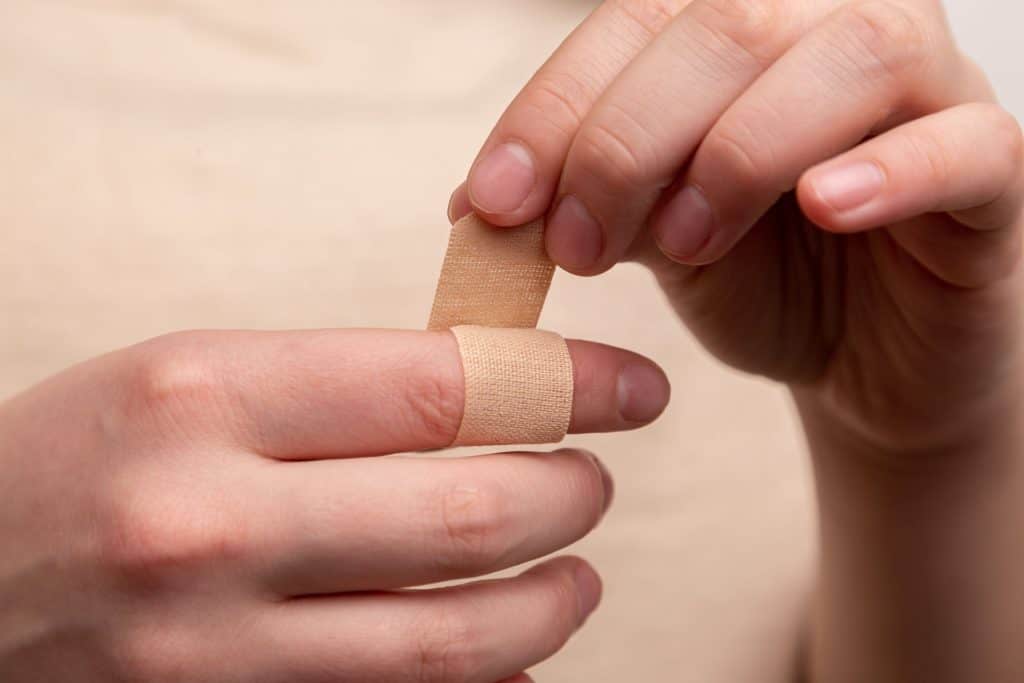 A person applying band-aid to rabbit bite