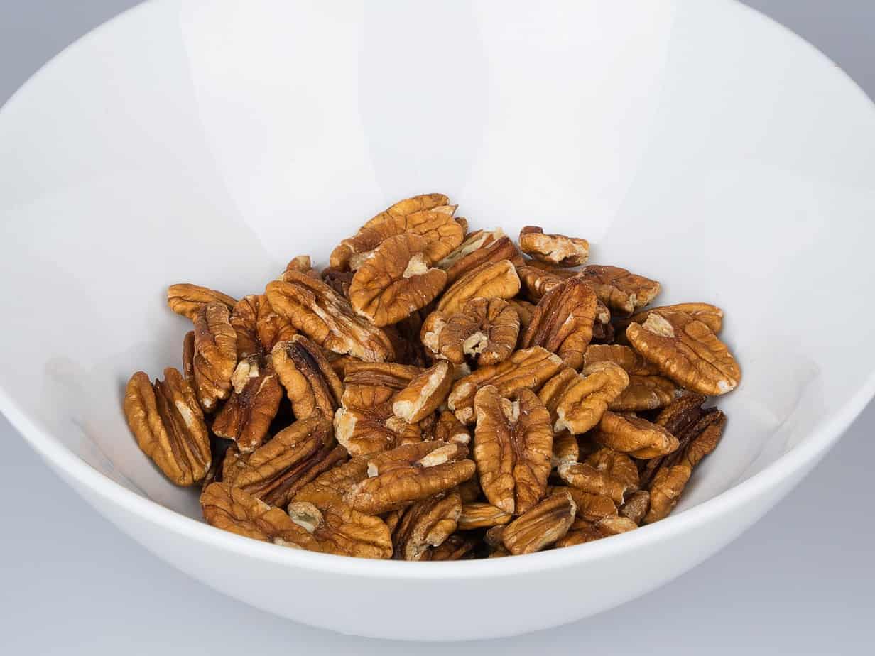 A bowl of unshelled pecans. Can rabbits eat pecans