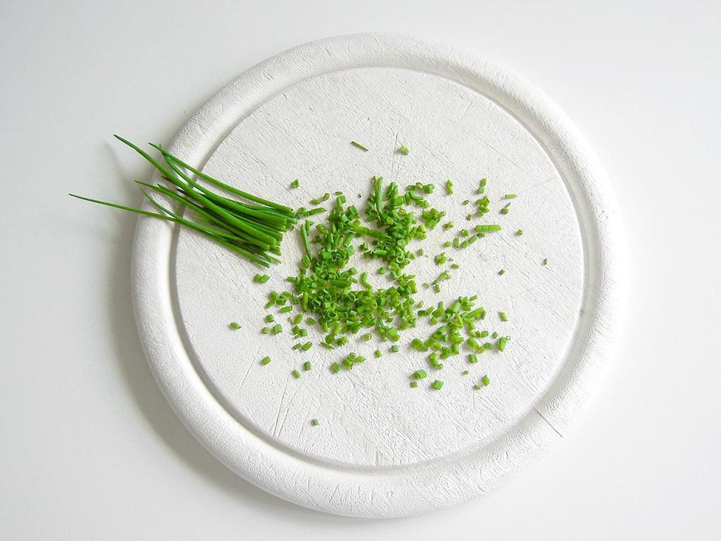 A chopped chives on a white plate